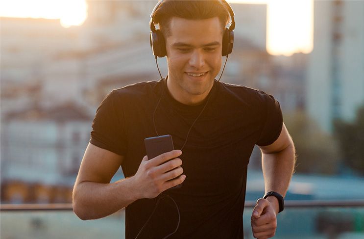 Man running on street with headphones